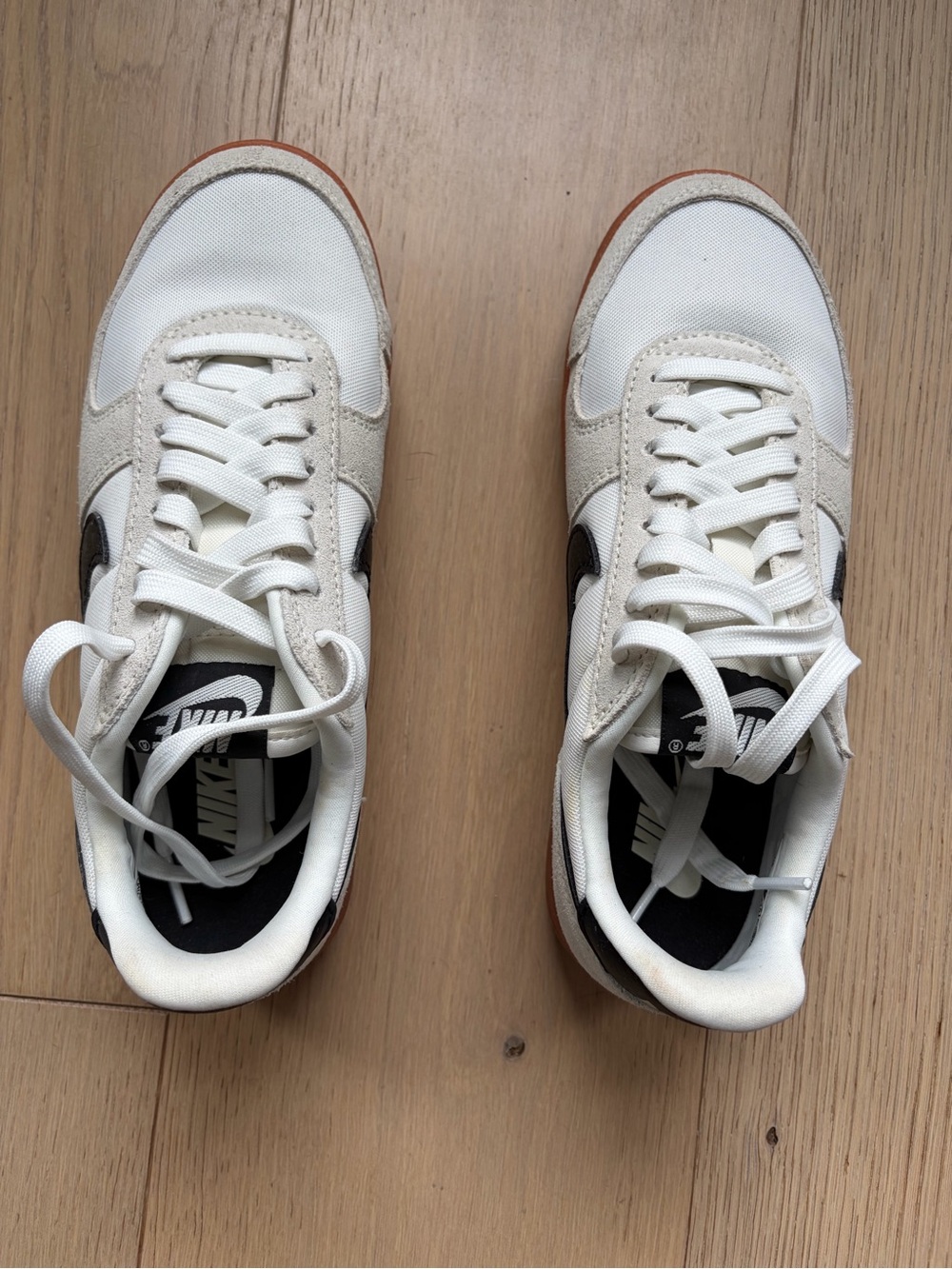 Nike Women’s White Sneakers with Brown Outsole and Black Swoosh